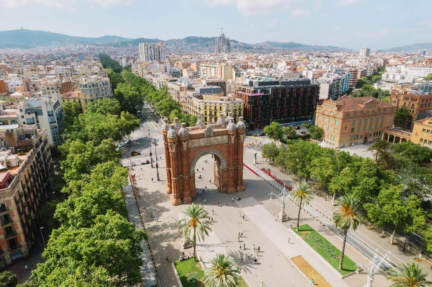 Aerial view of Barcelona Urban Skyline and The Arc de Triomf or Arco de Triunfo in spanish, a triumphal arch in the city of Barcelona. Sunny day.